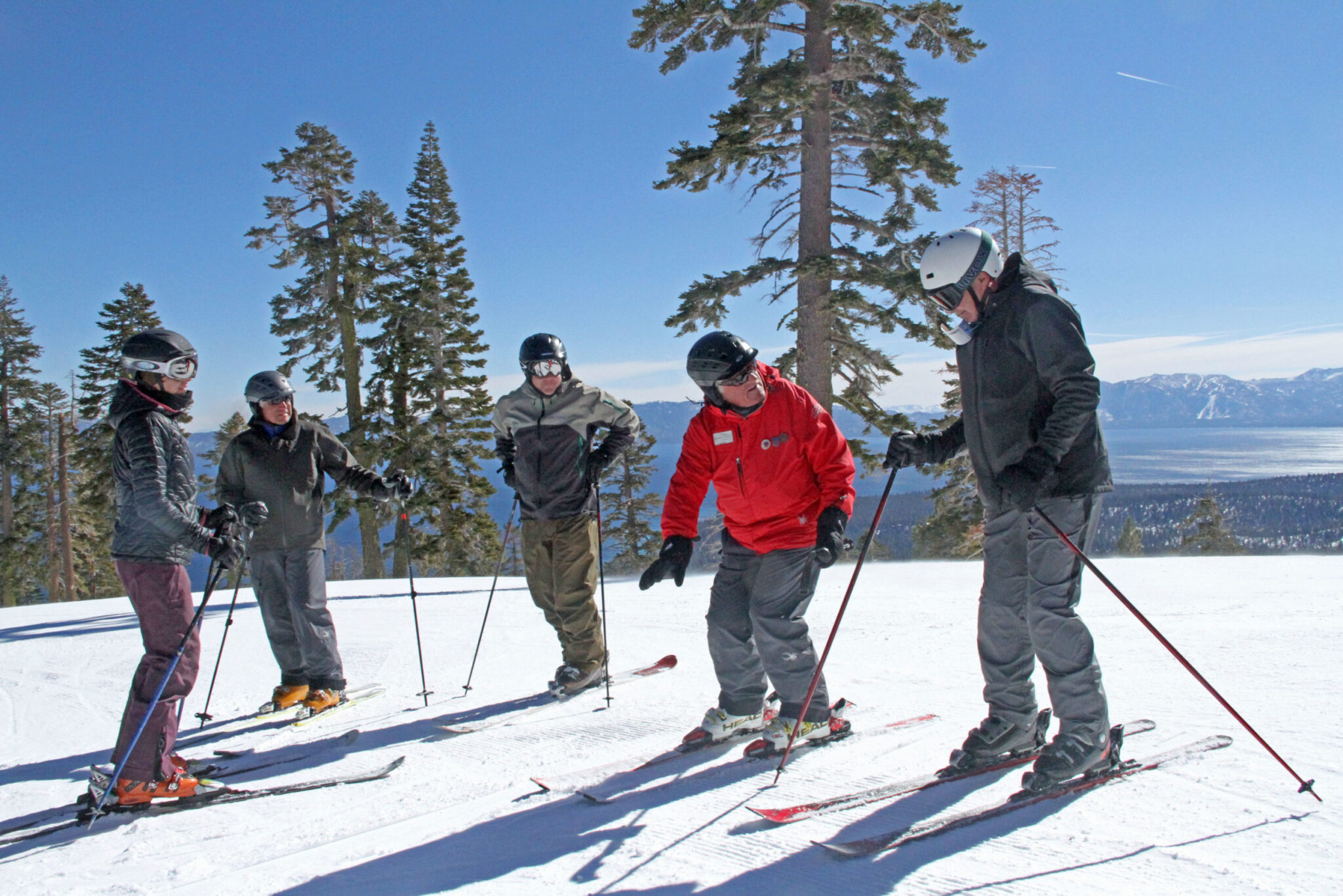 Instructor teaching a group ski lesson