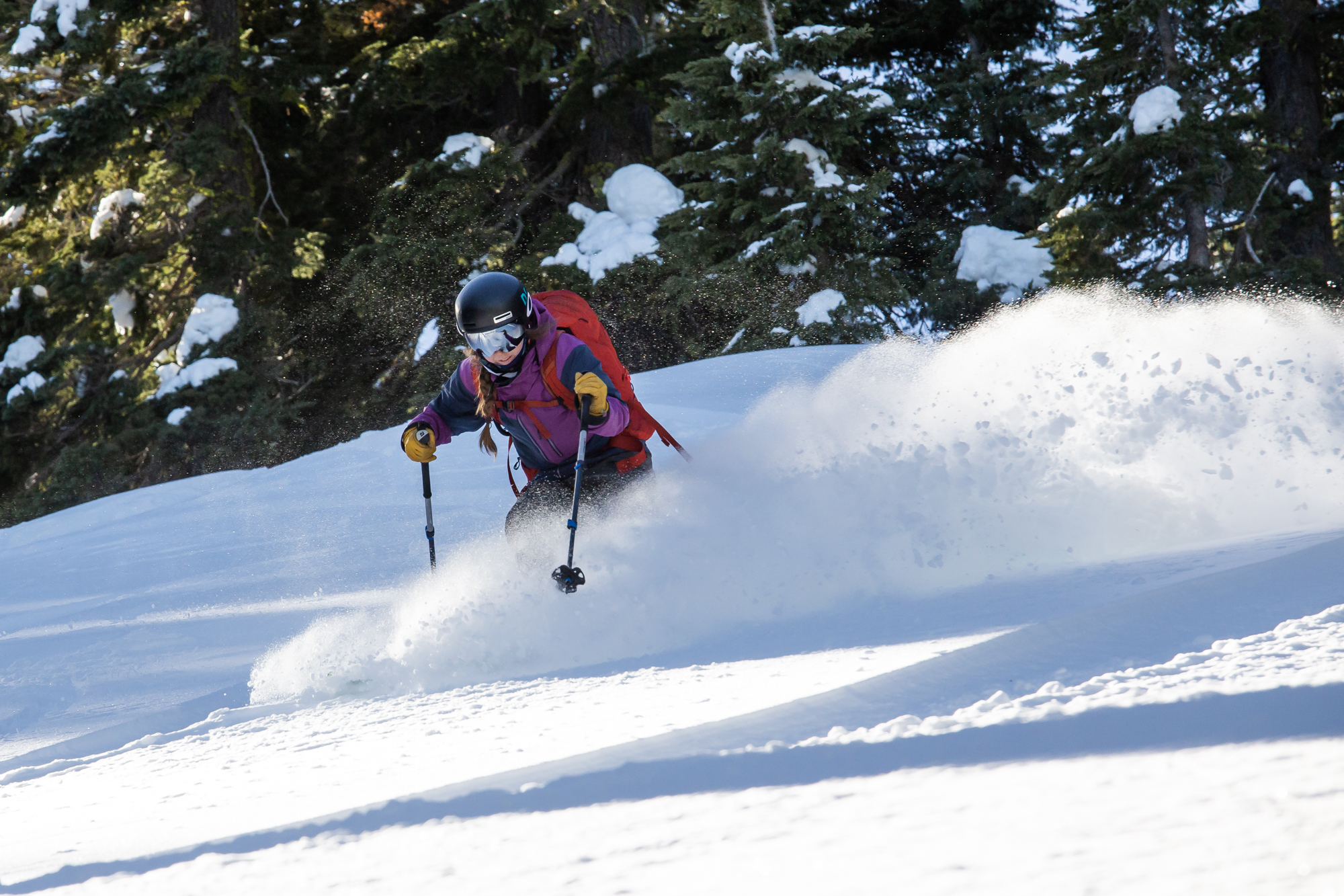 a skier navigates backcountry terrain